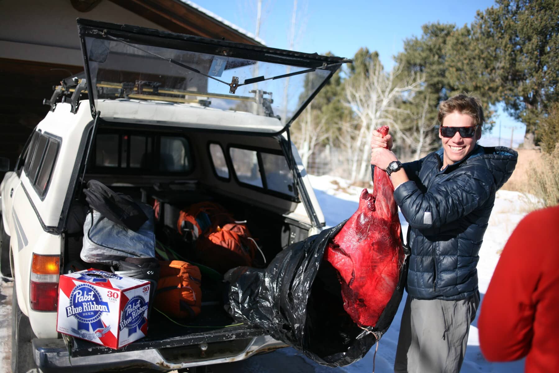 Kit pulling an elk quarter out a bag